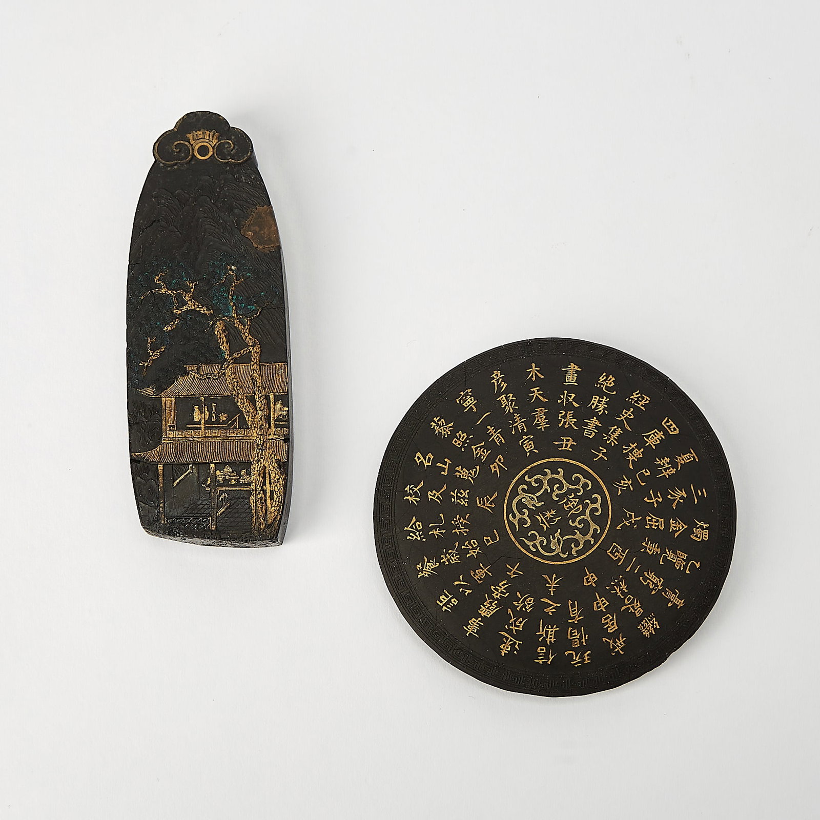 Two Chinese Gilt Decorated Ink Sticks Qing Dynasty: One decorated with figures in a two-story pavilion behind a tree, the other adorned with the twelve zodiac animals and an inscription containing the Twelve Earthly Branches. (Length of largest 4 1/2 i