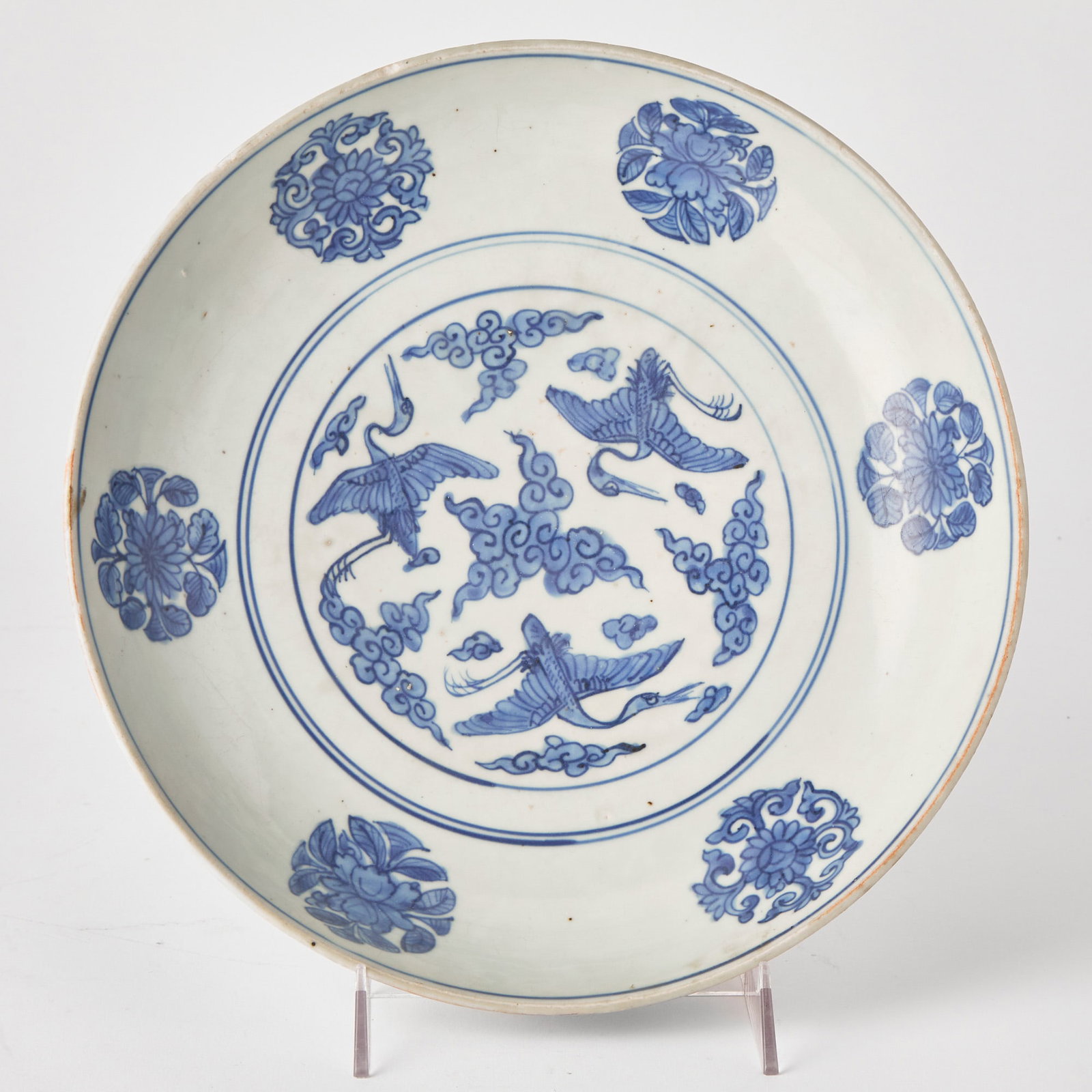 A Chinese Blue and White Porcelain Dish Jiajing Mark and of the Period: Decorated with floral roundels encircling three cranes amidst clouds; the dish of deep rounded form. (Diameter 12 inches)