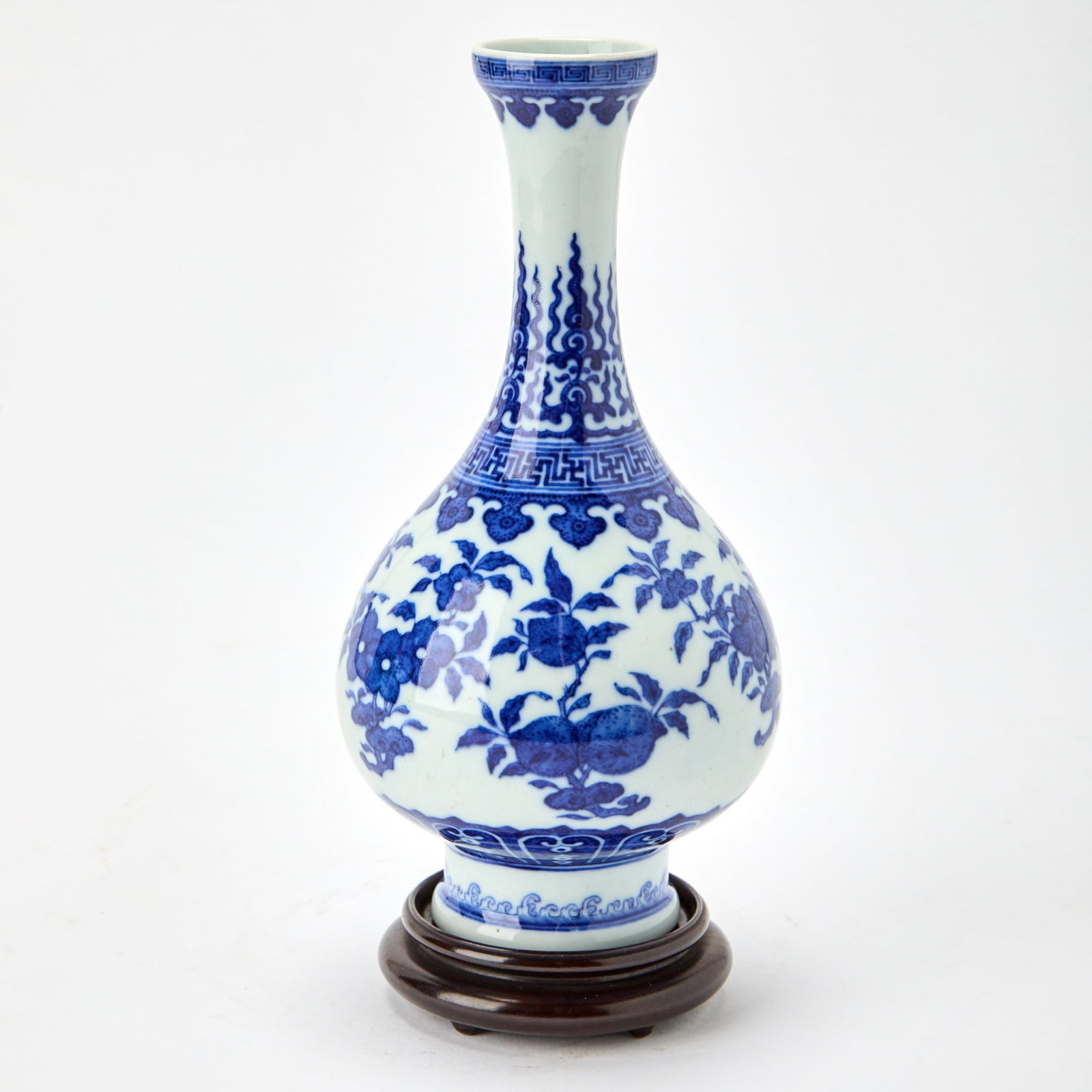 A Chinese Qianlong-Style Blue and White Porcelain Vase Qianlong Mark, Late Qing Dynasty: The pear-shaped body supported on a tall foot and rising to a cupped rim, the exterior painted with various floral sprays between decorative bands. (Height 9 inches) Overall good condition.