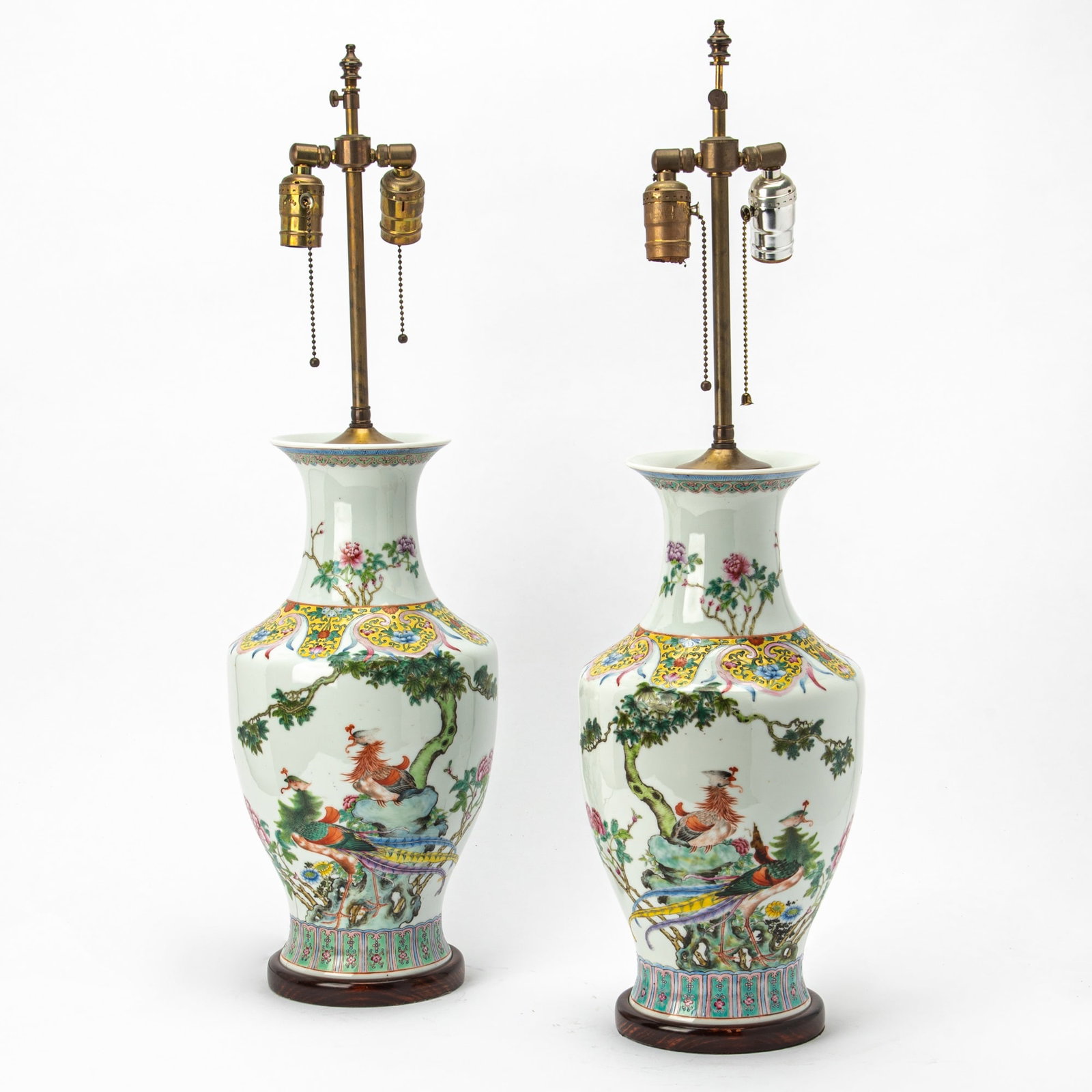 A Pair of Chinese Enameled Porcelain Vases Republic Period: Each decorated with a pair of phoenixes perched on rockwork beneath a tree. (Height 17 inches)
