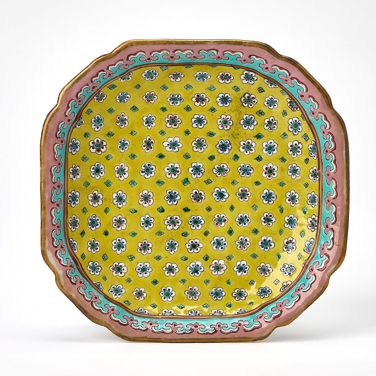 A Chinese Enameled Porcelain Footed Dish Tongzhi Mark, Qing Dynasty: Decorated with small florets and leaves against a yellow ground. (Diameter 6 3/4 inches)