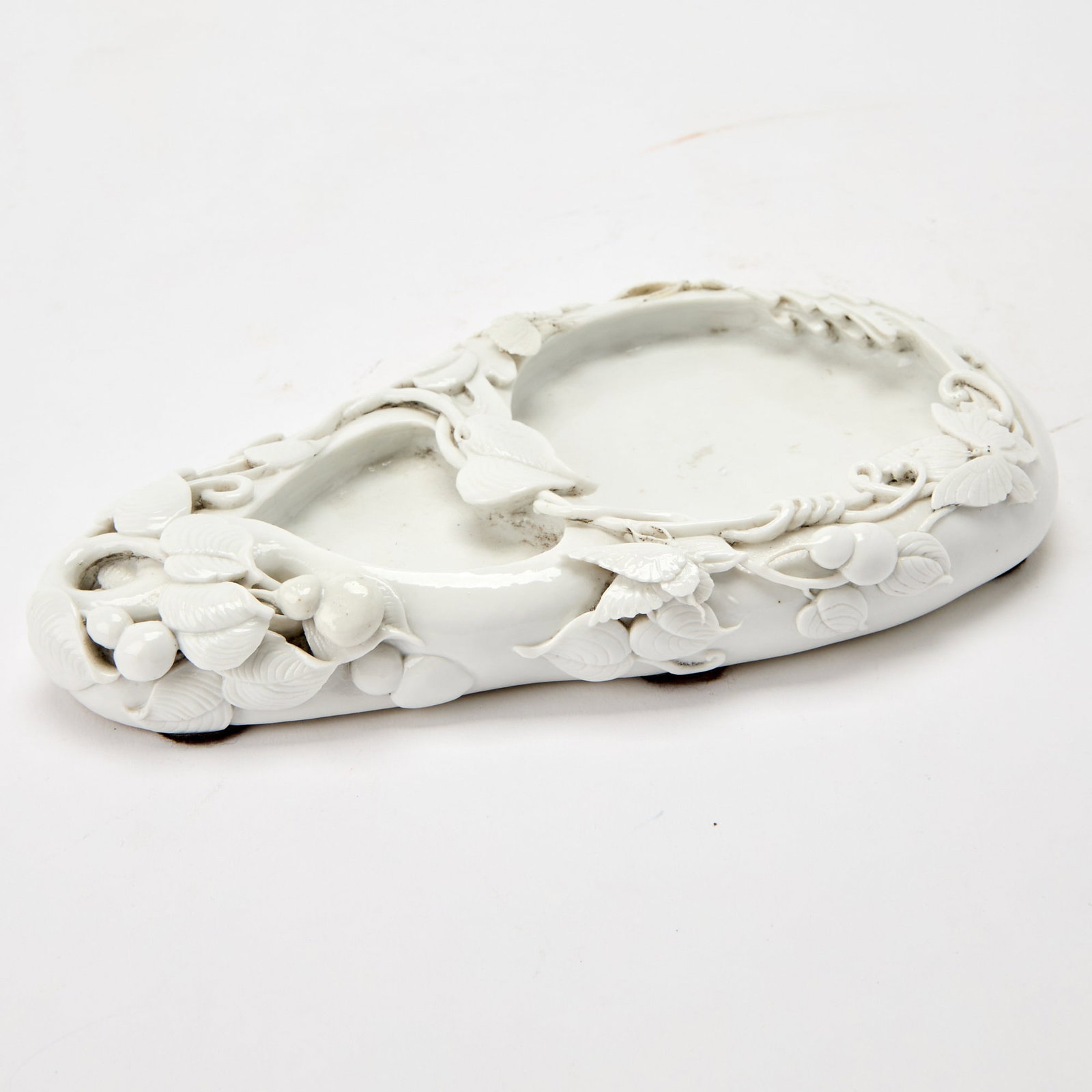 A Chinese Dehua Porcelain Dish Republic Period: Modeled in double-gourd form, decorated with leafy vines bearing gourds and butterflies. (Length 8 3/4 inches)