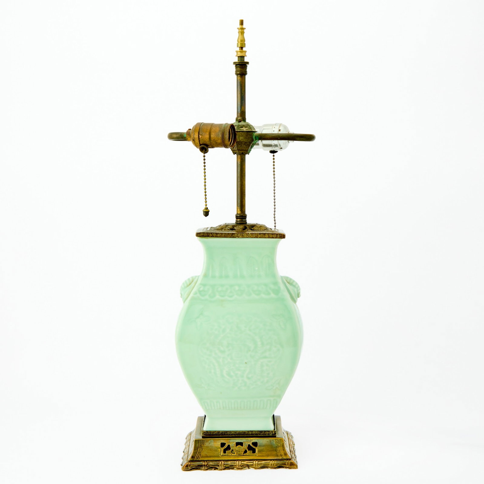 A Chinese Celadon Glazed Porcelain Vase 19th/20th Century: Of fanghu form; decorated with dragon roundels and shou medallions. (Height 10 1/2 inches)