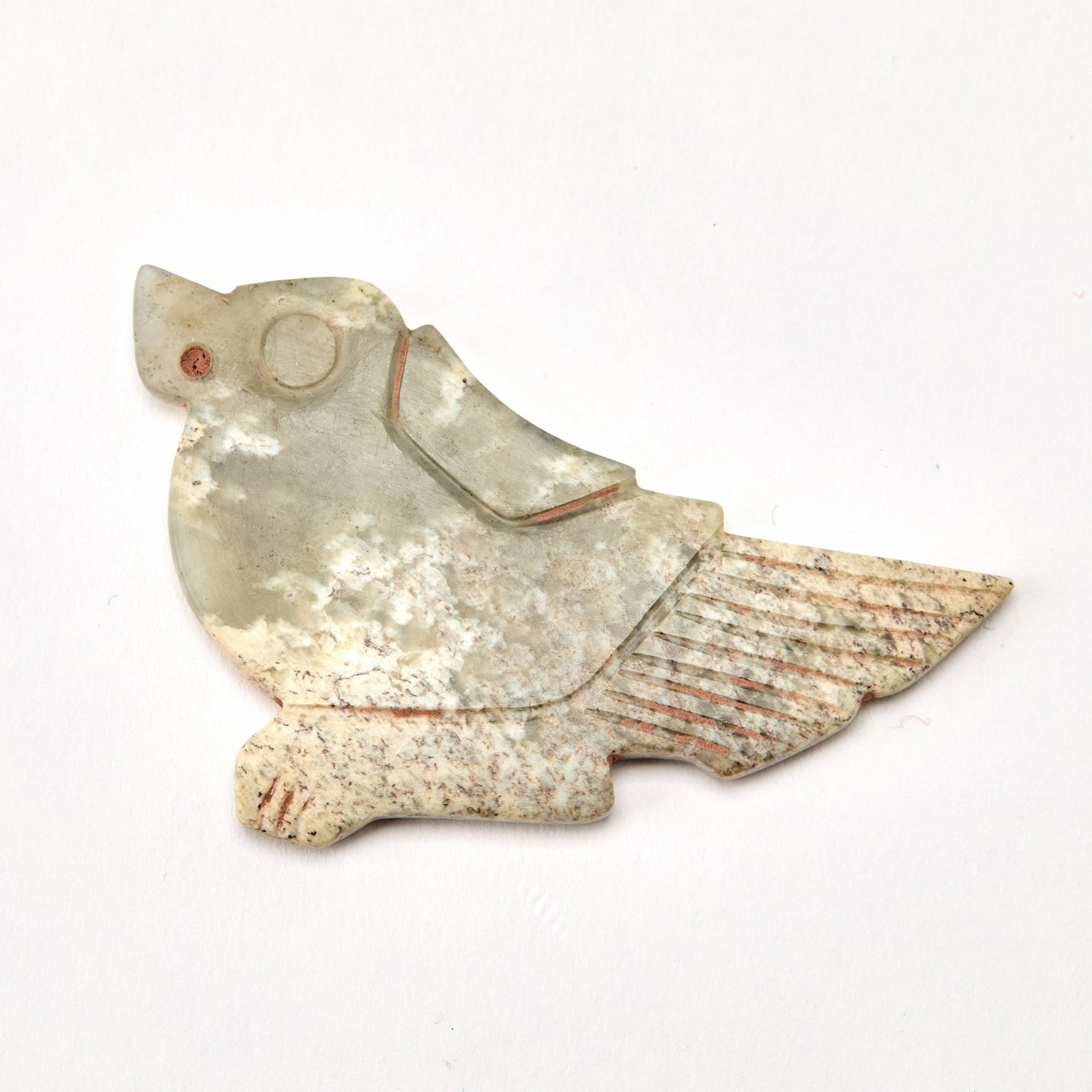 A Chinese Archaistic Jade Pendant of a Bird: Carved in flattened form as a stylized bird. (Length 2 1/4 inches)