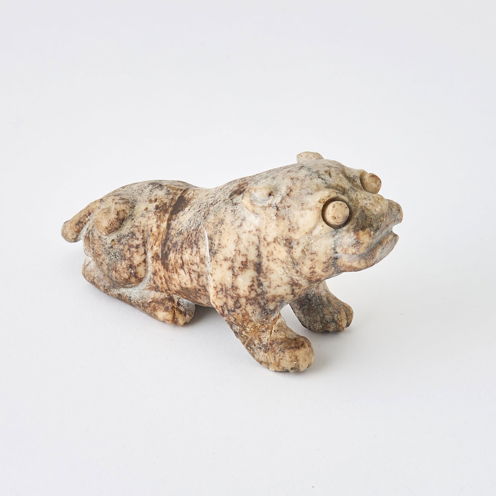 A Chinese Carved Jade Beast Ming Dynasty or Earlier: Carved as a crouching tiger. (Length 5 1/4 inches)