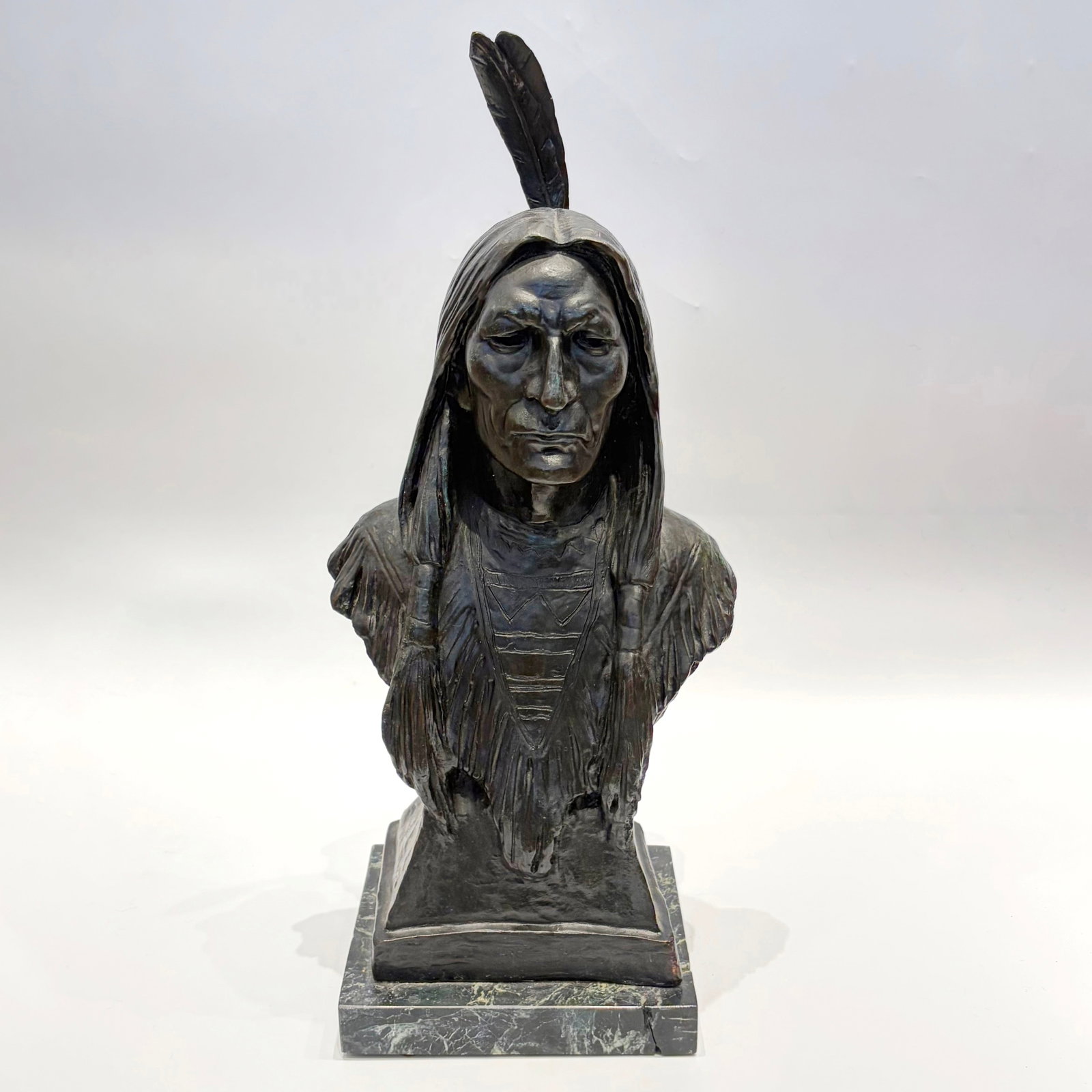 Max Bachmann: American, 1862-1921 Bust of Native American Signed Max Bachmann on the reverse Bronze with greenish-brown patina 22 x 9 1/2 x 6 inches overall