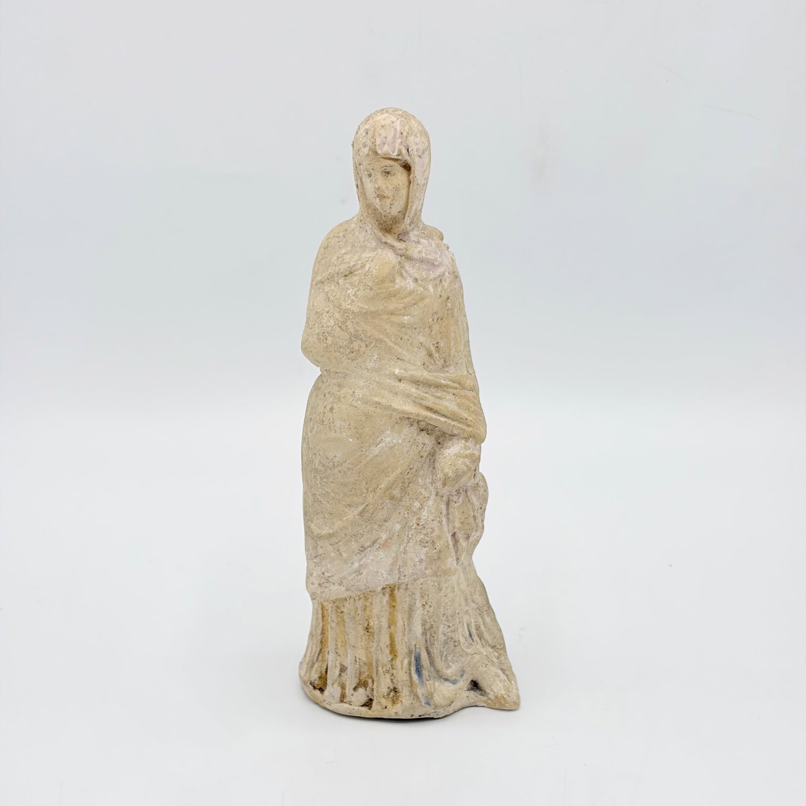 Greek Terracotta Tanagra Figure: Reportedly 3rd-2nd Century B.C. The standing veiled figure with traces of polychrome decoration. Height 7 1/2 inches Provenance: Auction, Skinner, April 23, 2005, lot 1096.