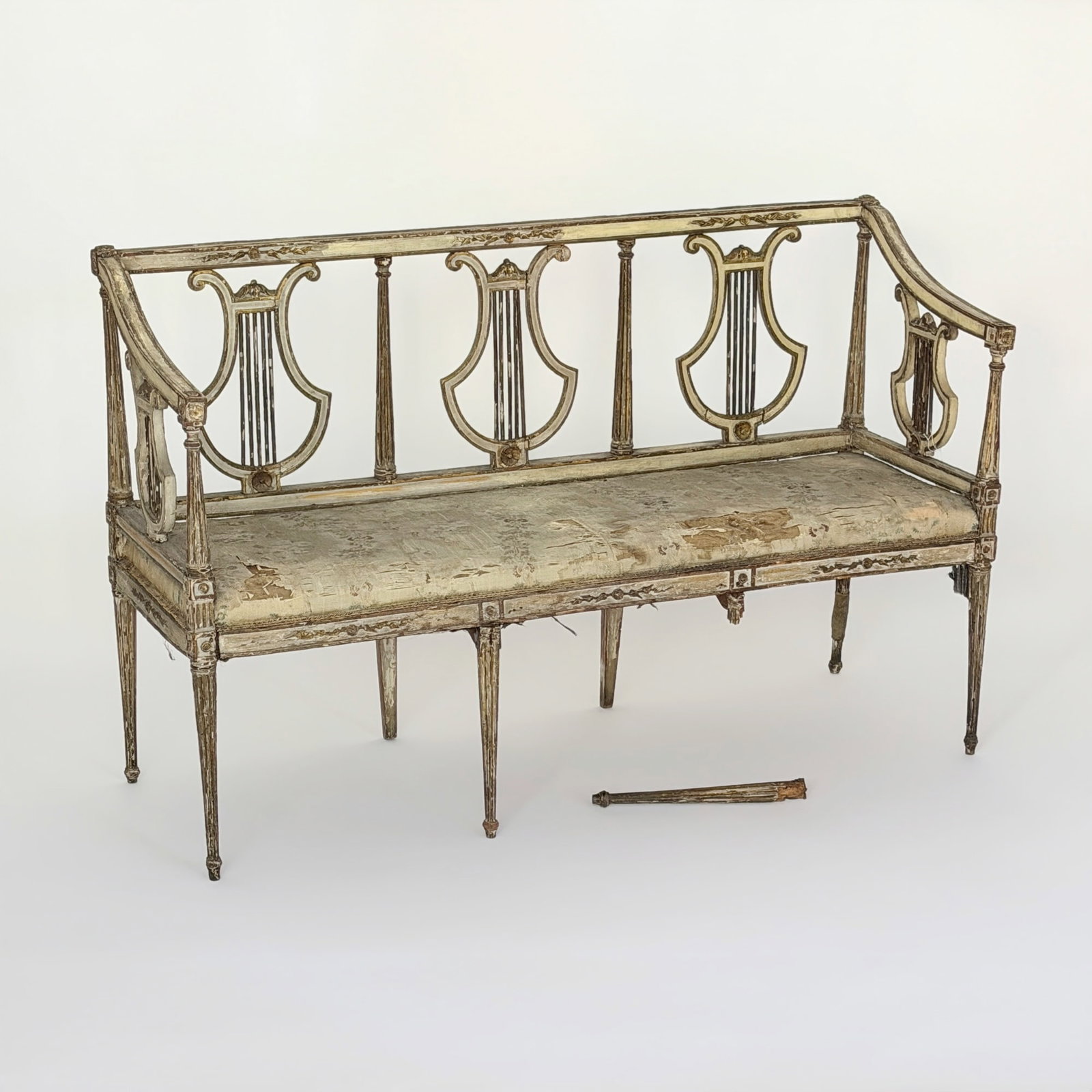 Italian White Painted and Gilt Triple Lyre Back Settee: Late 18th century Height 35 1/2 inches, length 55 1/2 inches, depth 20 inches. Provenance: Gift of Mrs. Walter Scott Fitz One leg detached
