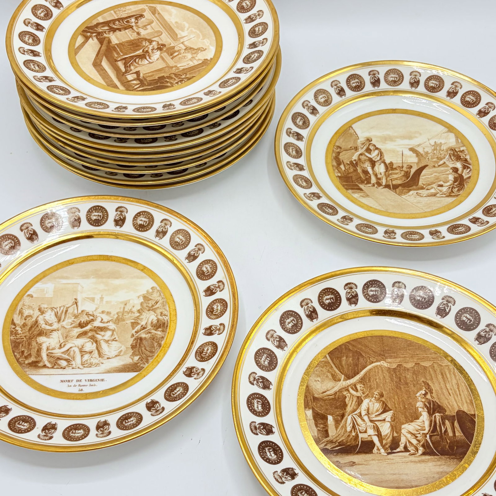 Set of Twelve Neoclassical Stone, Coquerel & Legros "Histoire Romaine" Porcelain Cabinet Plates: Early 19th century Diameter 9 inches; Together with Three Similar Stone, Coquerel & Legros Cabinet Plates. Diameter 9 inches.