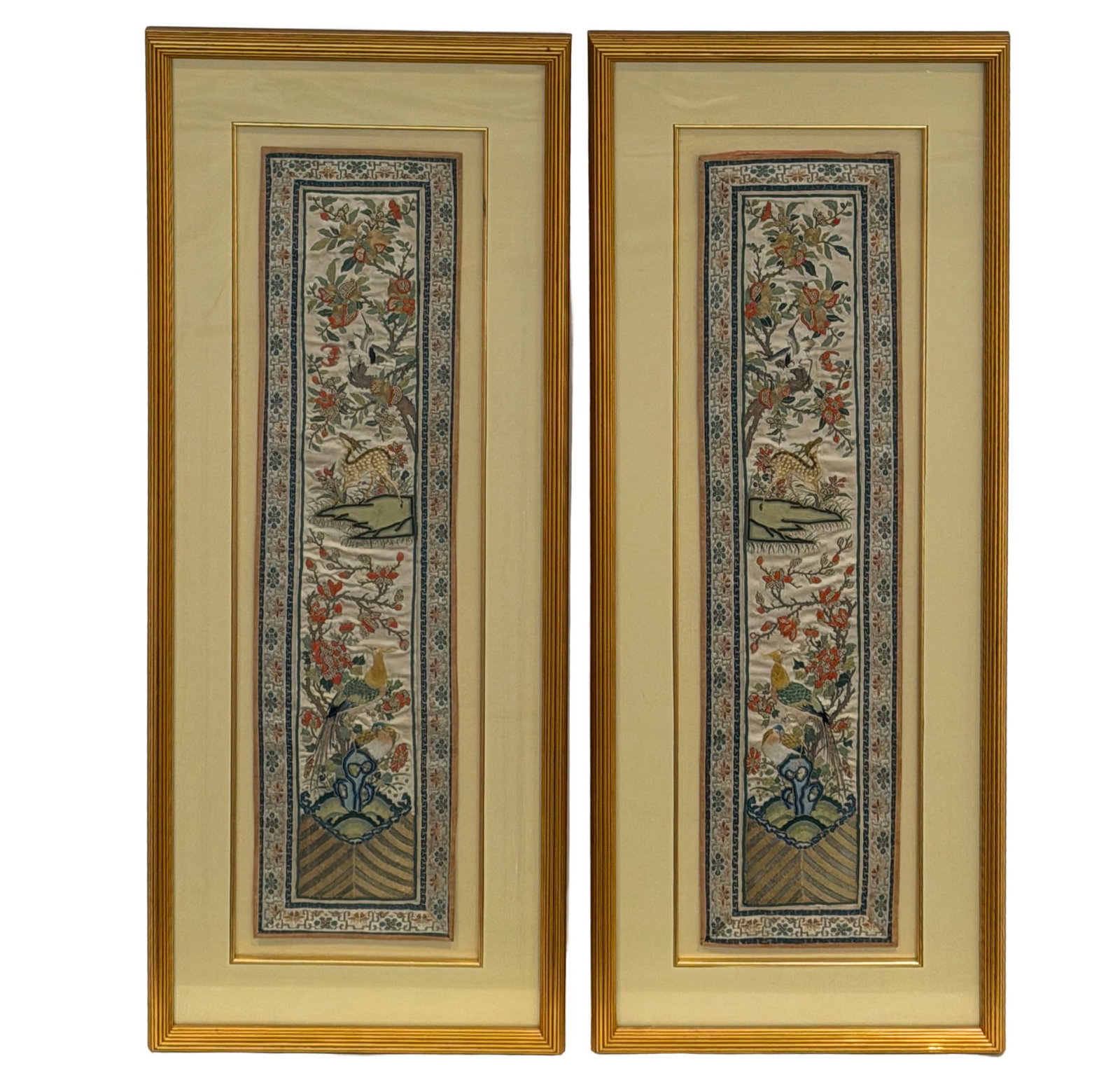 Pair of Asian Embroidery Panels: Each with floral border centering a reserve with trees and animals. Each 23 3/4 x 5 3/4 inches. Framed overall 30 1/2 x 12 1/4 inches