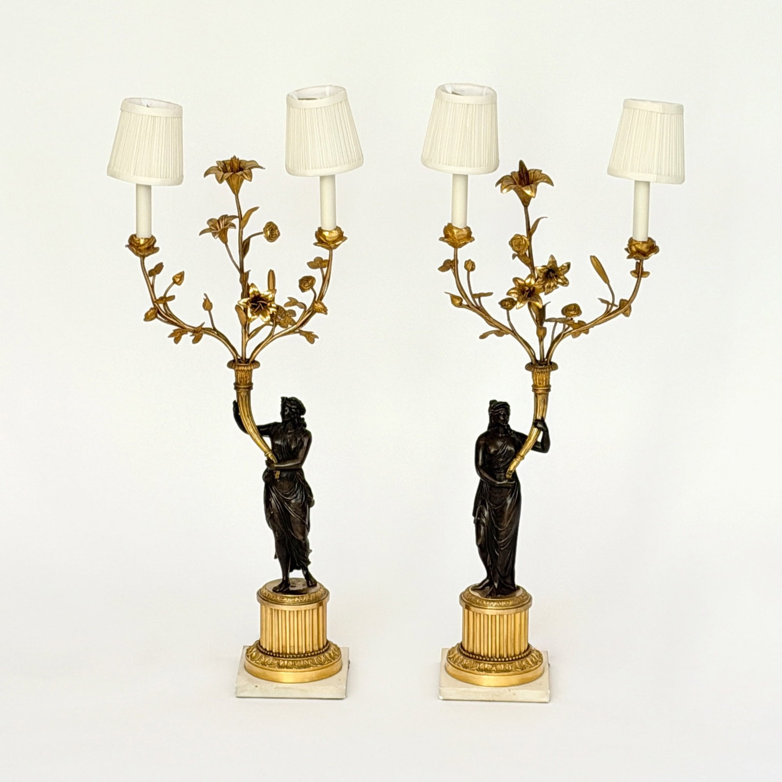 Pair of Empire Style Gilt-Bronze Two-Light Figural Candelabra: France, late 19th century Mounted as lamps. Height 34 1/2 inches.