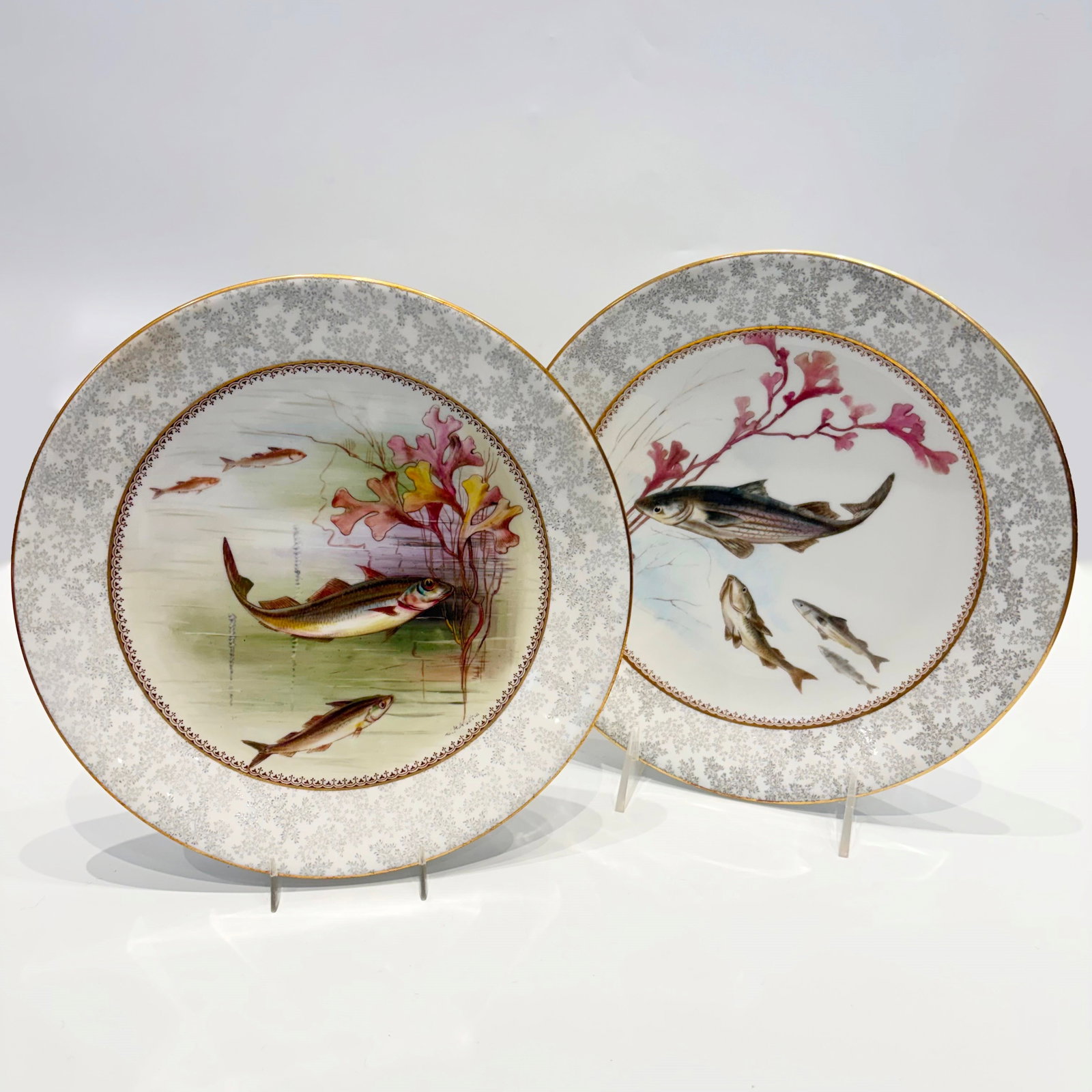 Set of Royal Worcester Hand-painted Fish Plates: Early 20th century Comprising sixteen plates, some signed by W. H. Austin, diameter 9 inches; and nine plates made for Caldwell, Philadelphia, diameter 9 1/4 inches. Each centering a fish among
