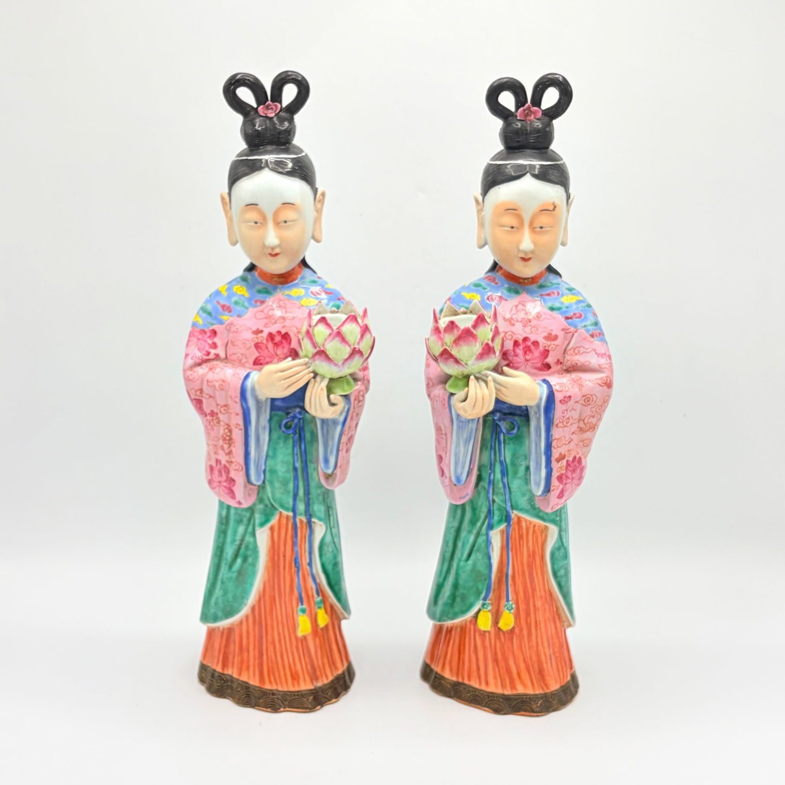 Pair of Chinese Porcelain Figural Candlesticks: Early 20th century Each candlecup in the form of a lotus flower. Height 17 inches.