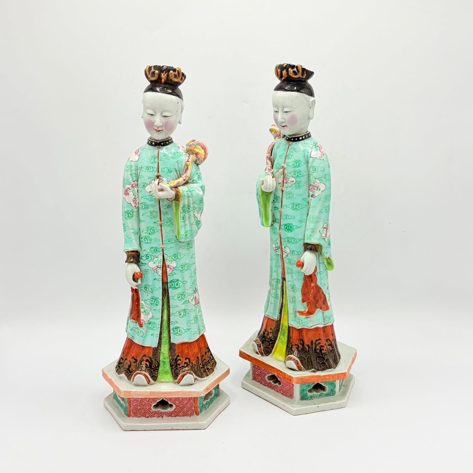 Pair of Chinese Famille Rose Porcelain Figures: Early 20th century With pierced hexagonal bases. Height 15 3/4 inches.