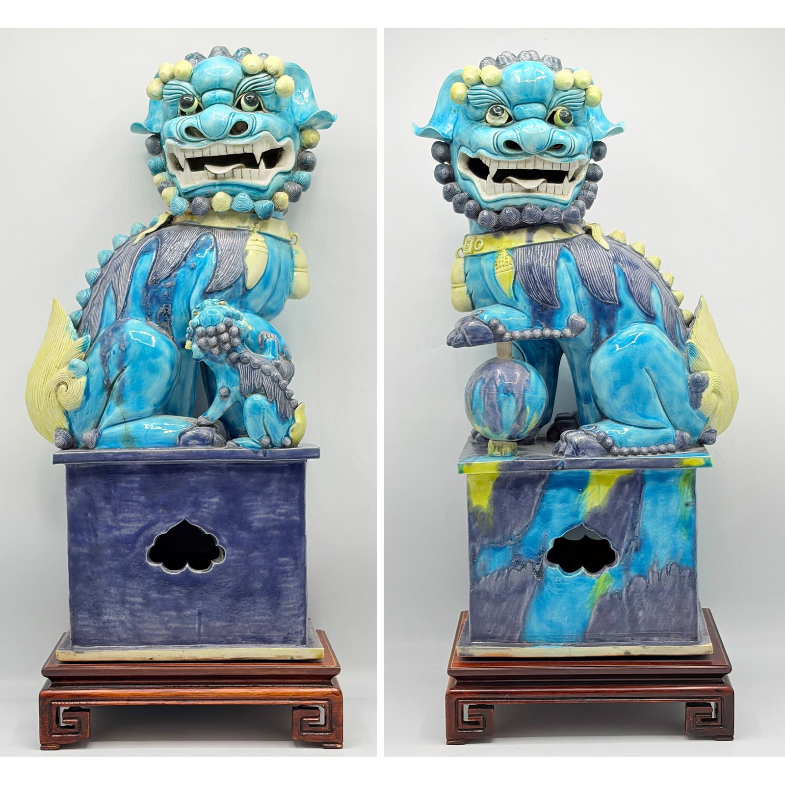 Pair of Chinese Glazed Porcelain Dragons: 20th century Each seated lion on a pierced square plinth and a hardwood base. Overall height 21 1/2 inches.