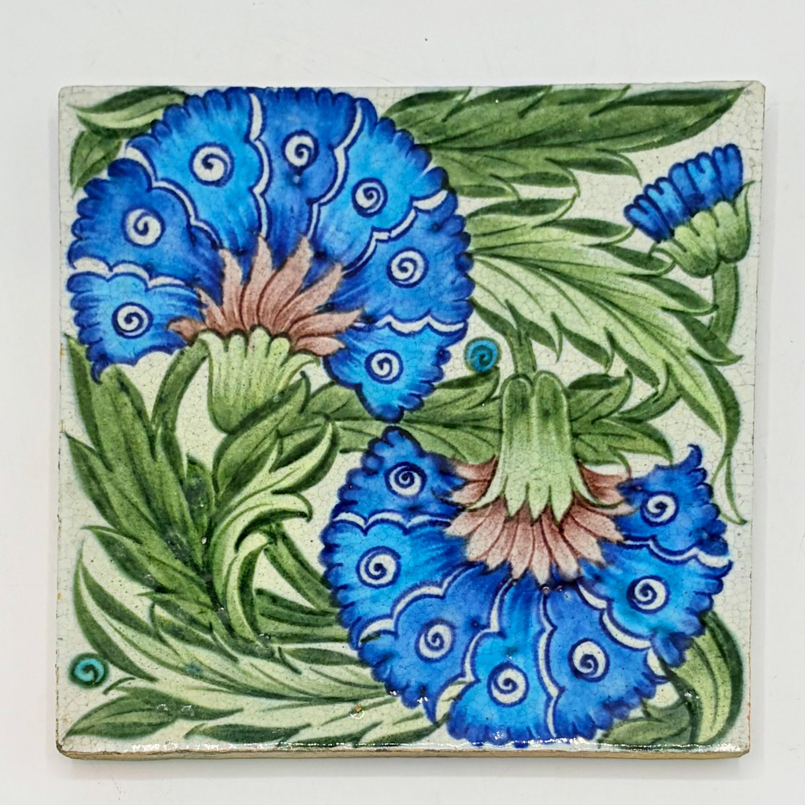 William de Morgan Glazed Earthenware "Double Carnation" Tile: England, circa 1898 With impressed DM 98 mark to reverse 8 x 8 inches. mark n, ill. Catleugh (p. 81)
