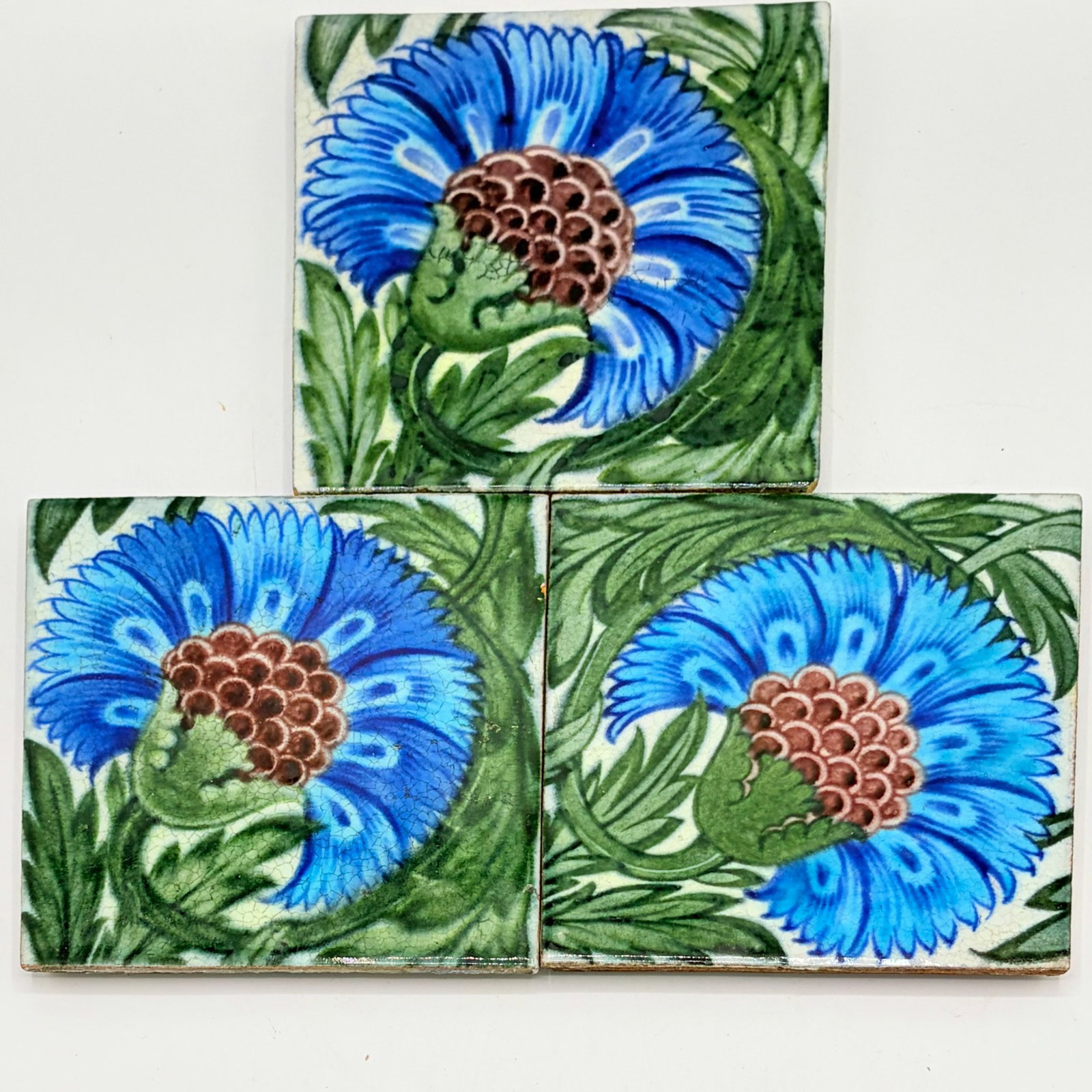 Three William de Morgan Glazed Earthenware B.B.B. Design Tiles: England, circa 1898-1907 Two examples with impressed DM 98 mark to reverse, one example with D.I.P. mark to reverse Each 6 x 6 inches. 12.1, 12.2 mark n, 12.3 mark o, ill. Catleugh (p. 80).