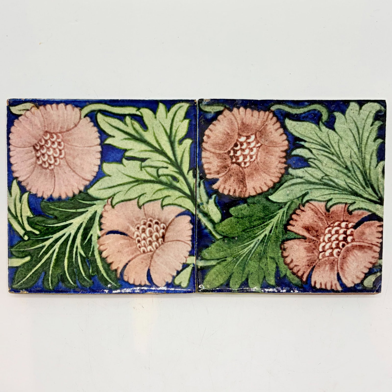 Two William de Morgan Glazed Earthenware "K.L Rose" Tiles: England, circa 1882-1898 One example with impressed De Morgan Merton Abbey mark to reverse, the other with impressed Sand's End Pottery-Fulham mark to reverse Each 6 x 6 inches. 3.1 mark k, 3.2 mark h