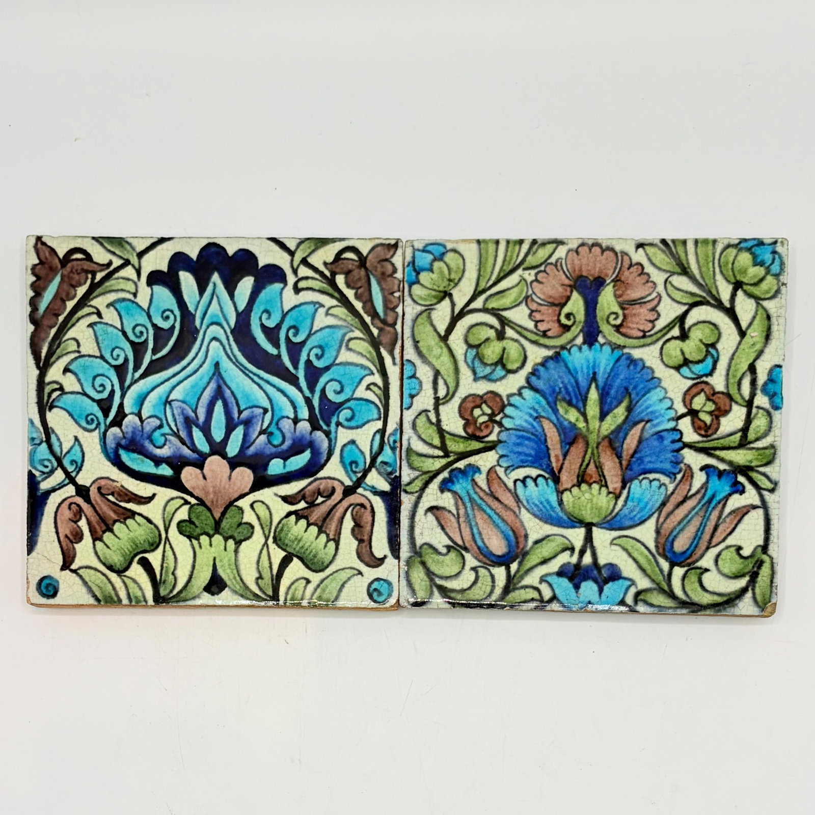 Two William de Morgan Glazed Earthenware Islamic Design Tiles: England, c. 1888-1898 One example with impressed Sand's End Pottery-Fulham mark to reverse, the other example with impressed DM 98 mark to reverse Each 6 x 6 inches. 8.1 mark n, 8.2 mark k, ill. Catle