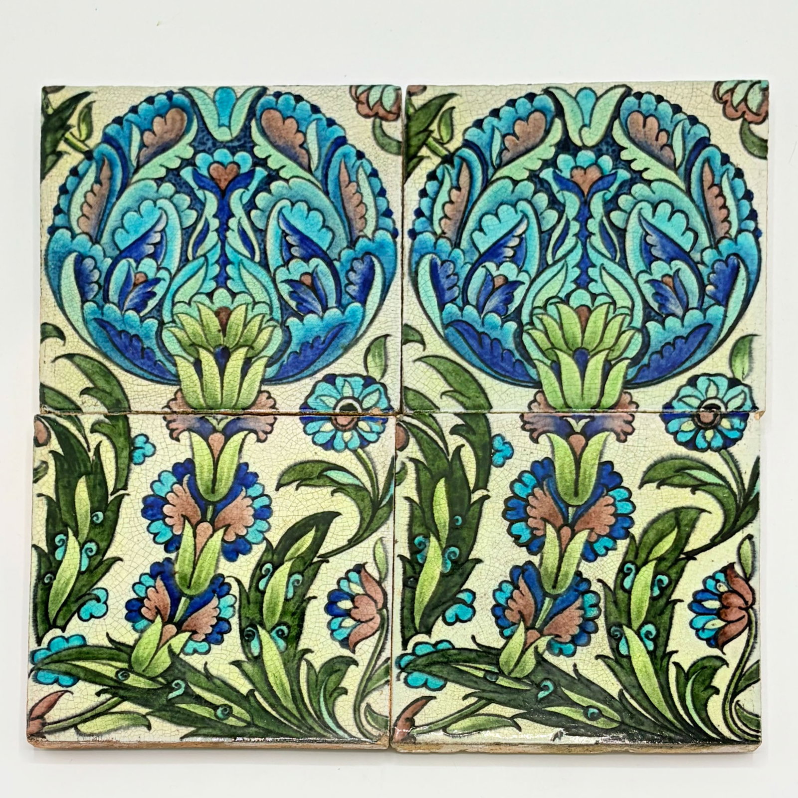 Four William De Morgan Glazed Earthenware Islamic Design Tiles: England, circa 1888-1907 Two examples with impressed Sand's End Pottery mark to reverse, two examples with impressed DM 98 mark to reverse Each 6 x 6 inches. 10.1, 10.3 mark k, 10.2, 10.4 mark n, ill.