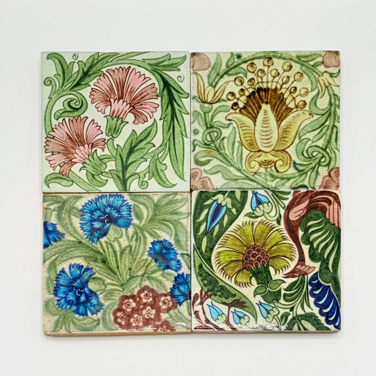 Four William de Morgan Glazed Earthenware Tiles: England, circa 1882-1898 One example with impressed De Morgan Merton Abbey mark to reverse, two examples with impressed Sand's End Pottery mark to reverse, one example with impressed DM 98 mark to rev