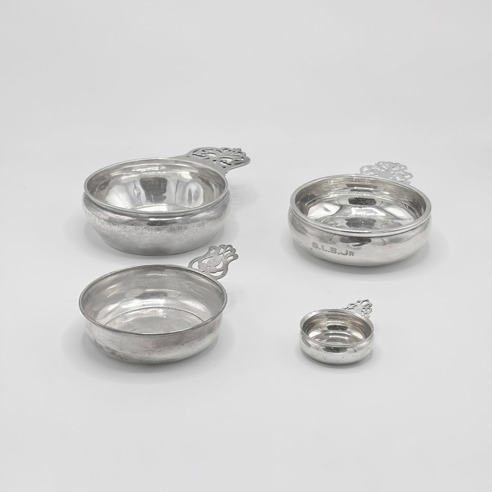 Group of Four American Sterling Silver Porringers: Comprising examples by The Handicraft Shop, Lunt, Webster, and Richard Dimes Co., 20th century Length of largest over handle 7 1/2 inches, total approximately 15 ounces.
