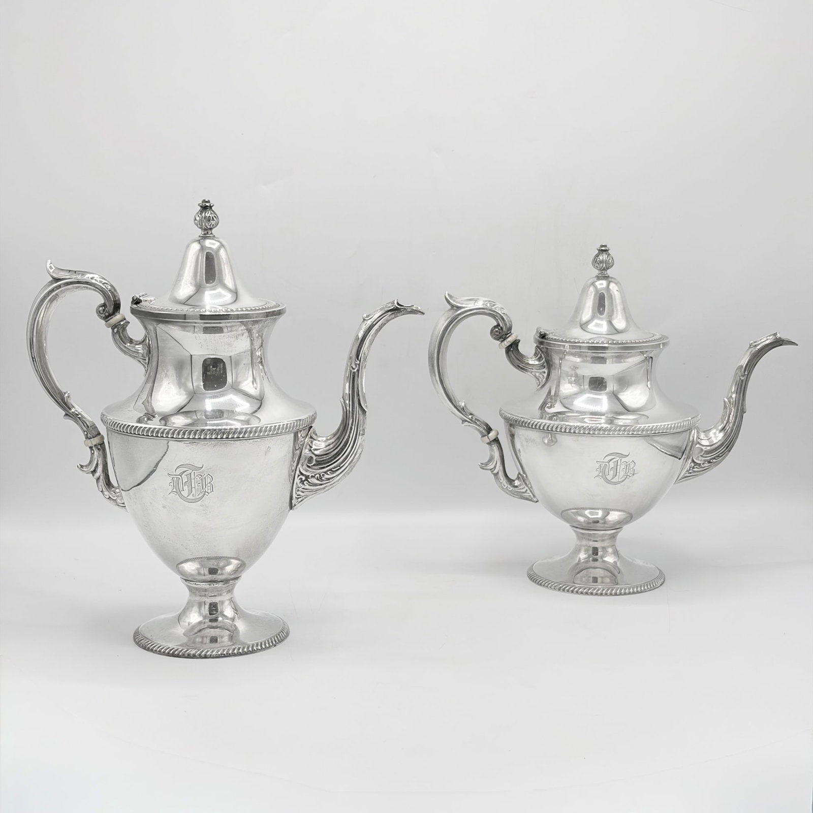 American Sterling Silver Coffee Pot and Teapot: M. Fred Hirsch & Co., mid 20th century Each urn-form with rope twist bands, with scrolling spout and loop handle. Height of coffee pot 12 inches, total approximately 47 ounces, all in. This item
