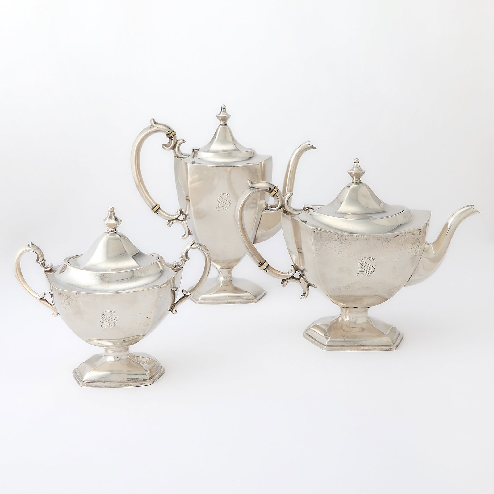 American Sterling Silver Part Tea and Coffee Service: Richard M. Woods Comprising a teapot, coffee pot and a covered sugar bowl. Height of coffee pot 10 inches, total approximately 44 ounces, all in. This item may contain elephant ivory, and in
