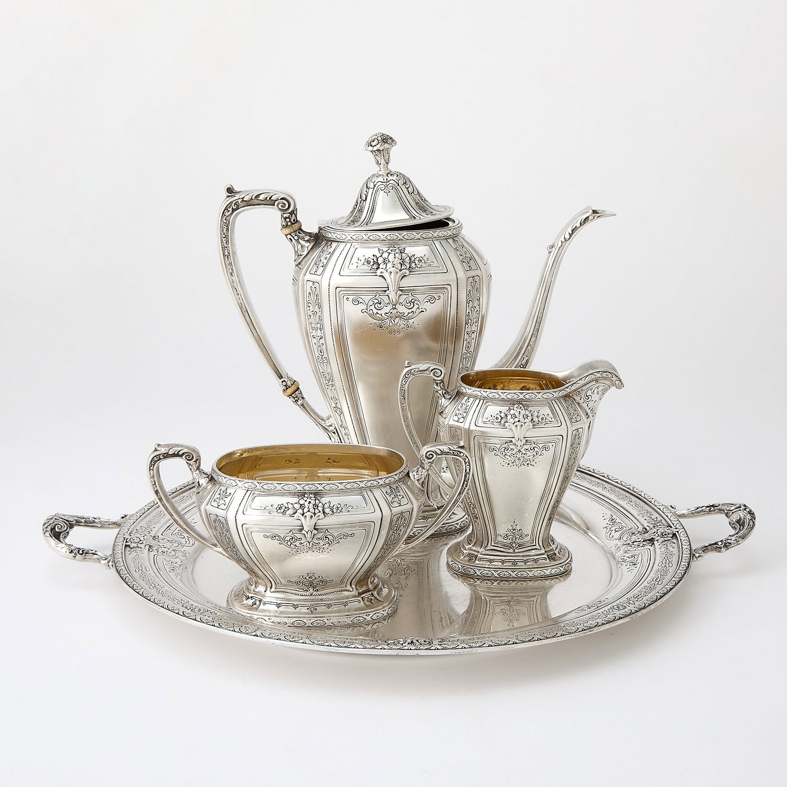 Towle Sterling Silver "D'Orleans" Pattern Demitasse Coffee Service: Comprising a coffee pot, height 8 3/4 inches, cream jug, sugar bowl and two-handled tray, length over handles 15 inches, total approximately 52 ounces. This item may contain elephant ivory, and in