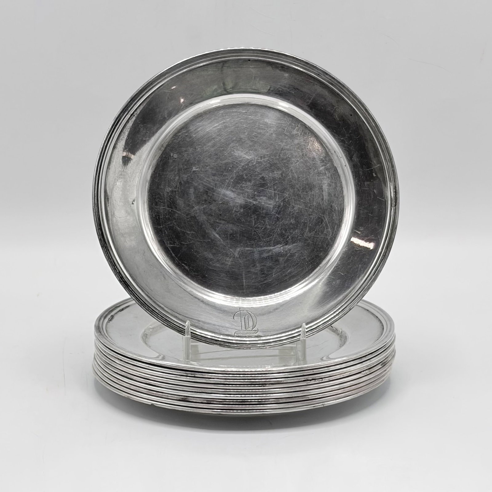 Set of Ten American Sterling Silver Bread Plates: 20th Century Circular with reeded border. Diameter six inches, total approximately 33 ounces.
