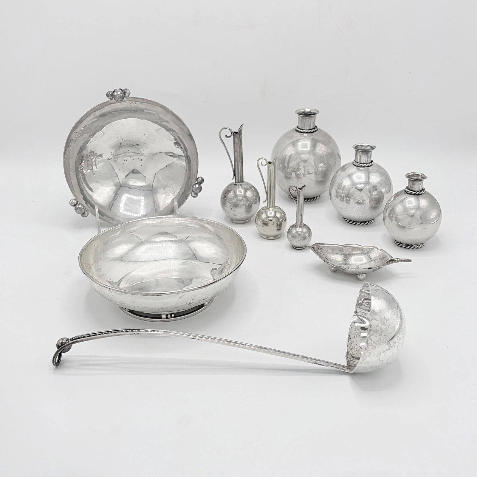 Group of Sciarrotta Sterling Silver Table Articles: Mid 20th century Comprising a set of three graduated bud vases, height of tallest 4 3/4 inches; a set of three graduated ewers, height of tallest 5 inches; two bowls, diameter of larger 6 1/2 inches;