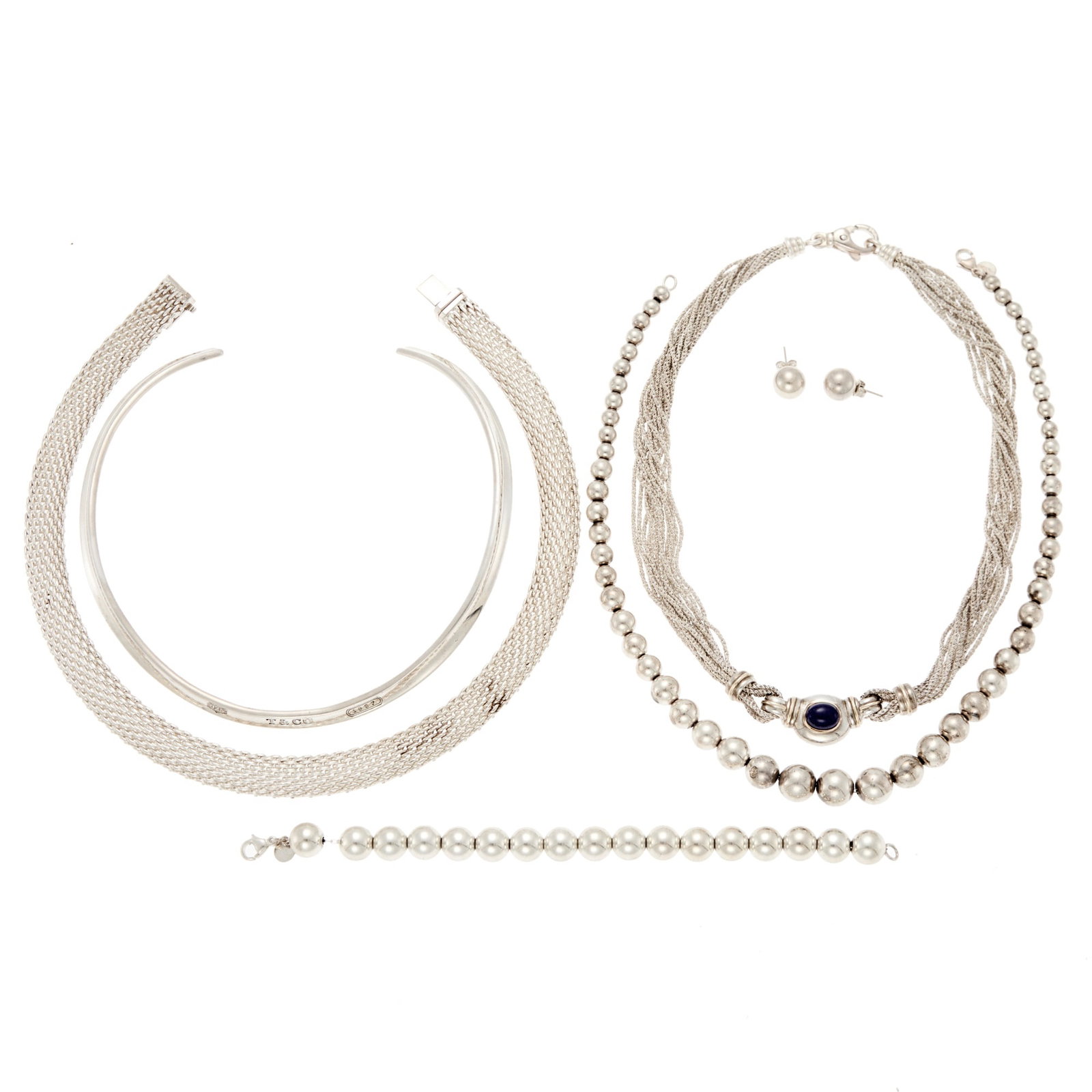 Tiffany & Co. Group of Silver Jewelry: .925 silver, one oval cabochon lapis ap. 10.0 x 7.0 mm., one necklace and pair of earrings signed T&Co., 3 necklaces and one bracelet signed Tiffany & Co., ap. 162.3 dwts. gross. Lengths 17