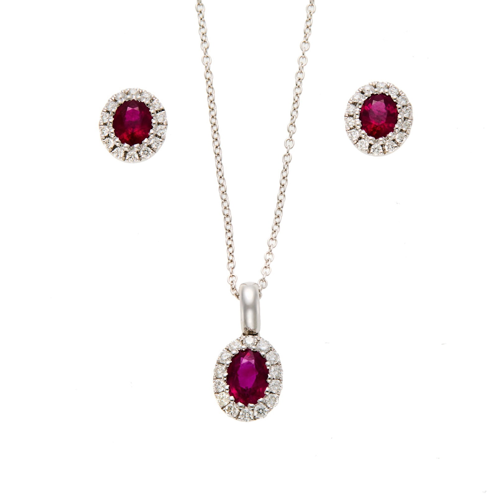 White Gold, Ruby and Diamond Pendant with Chain Necklace and Pair of Earrings: 18 kt., 3 oval rubies weighing 1.43 cts., 44 round diamonds weighing .34 ct., weights inscribed, with English assay marks, ap. 3.3 dwts. gross. Length 16 inches. Rubies: medium deep slightly