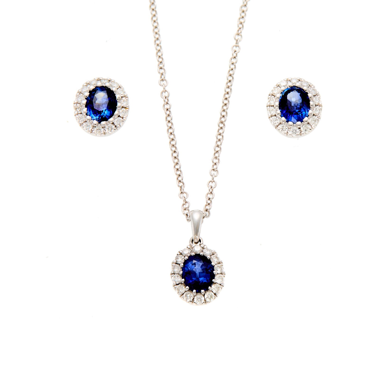 White Gold, Sapphire and Diamond Pendant with Chain Necklace and Pair of Earrings: 18 kt., 3 oval sapphires ap. 1.40 cts., 42 round diamonds ap. .40 ct., with English assay marks, ap. 3.3 dwts. gross. Length 16 inches. Sapphires: dark slightly violetish-blue, cleanish. Diamonds: H-I