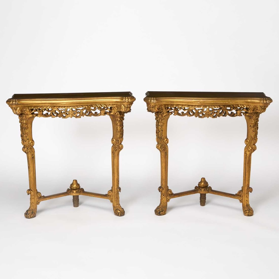 Pair of Louis XVI Style Carved Giltwood Consoles: Mid-20th century Height 32 inches, width 33 1/2 inches, depth 12 inches.