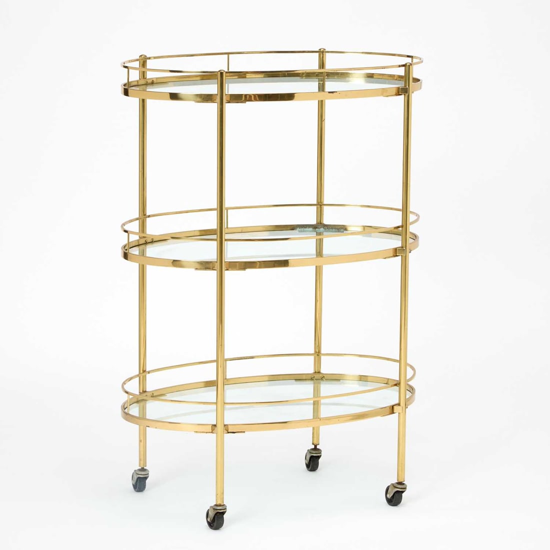 Brass and Glass Oval Shaped Three-Tier Trolley: Modern Height 42 inches, width 30 inches, depth 18 inches.