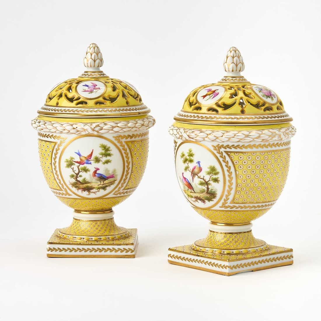 Pair of Paris (Le Rosey) Gilt and Hand-Painted Porcelain Covered Potpourri Vases: Circa 1890 In the Sèvres style, each of urn form with a pierced domed cover decorated with circular reserves depicting a colorful bouquet, against a yellow ground, inscribed in red Le Rosey XI Ru