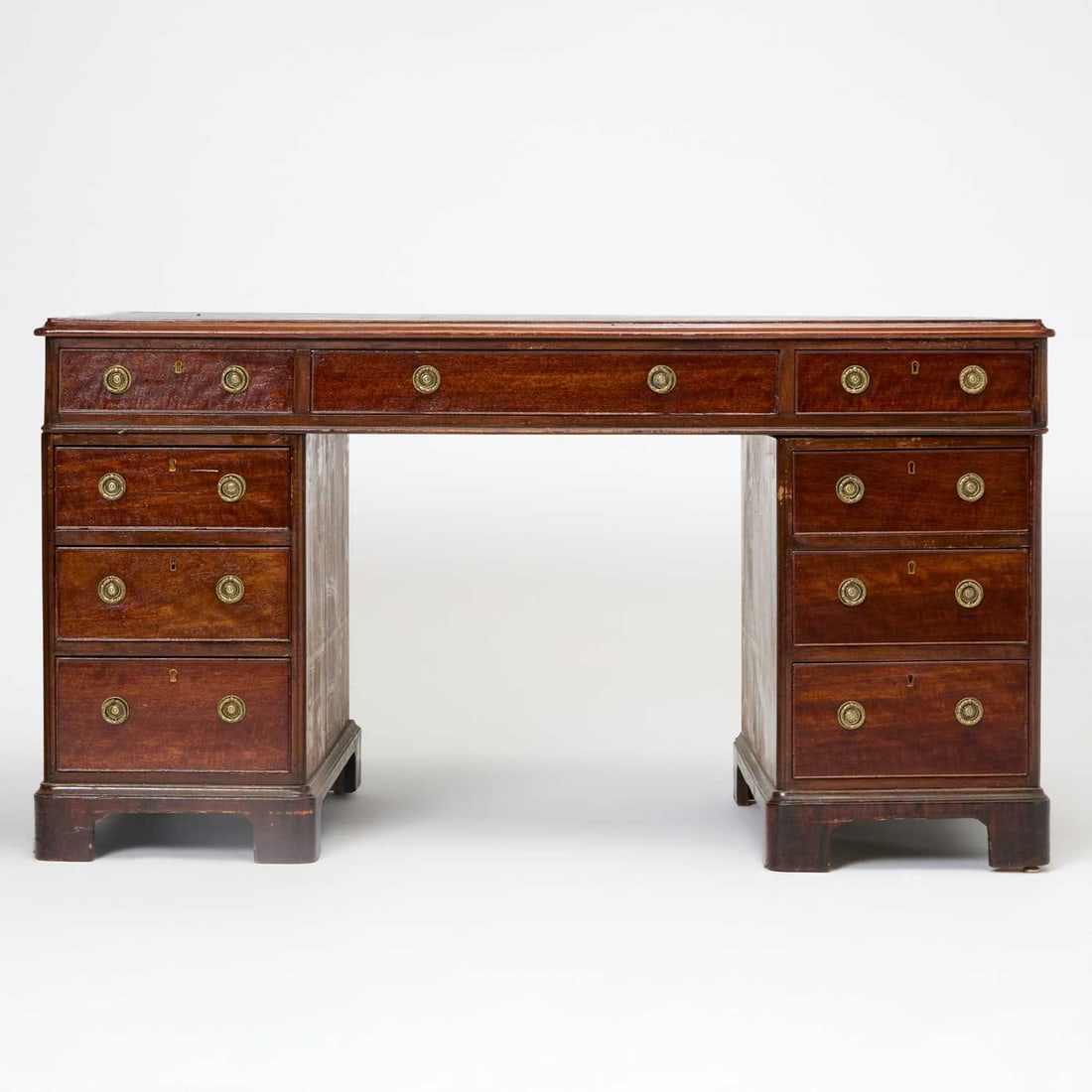 Regency Style Mahogany Pedestal Desk: 19th century In three parts, with a green leather inset top. Height 29 inches, width 53 1/2 inches, depth 29 inches. scratched and dented