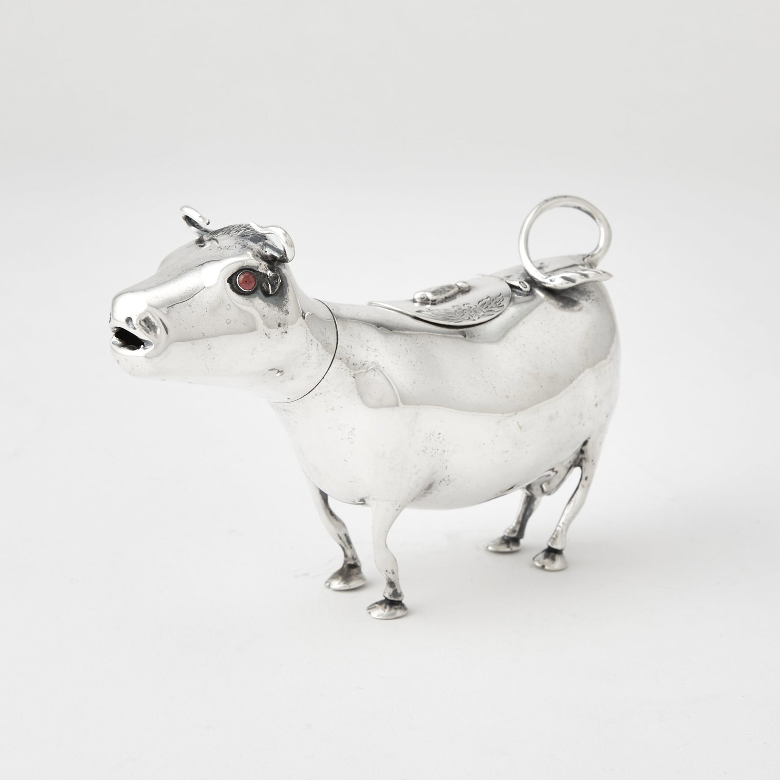 Dutch Silver Cow Creamer: Late 19th century Realistically modelled, the back with hinged cover. Height 3 3/4 inches (9.5 cm), length 5 1/2 inches (14 cm), approximately 4 ounces, all in.
