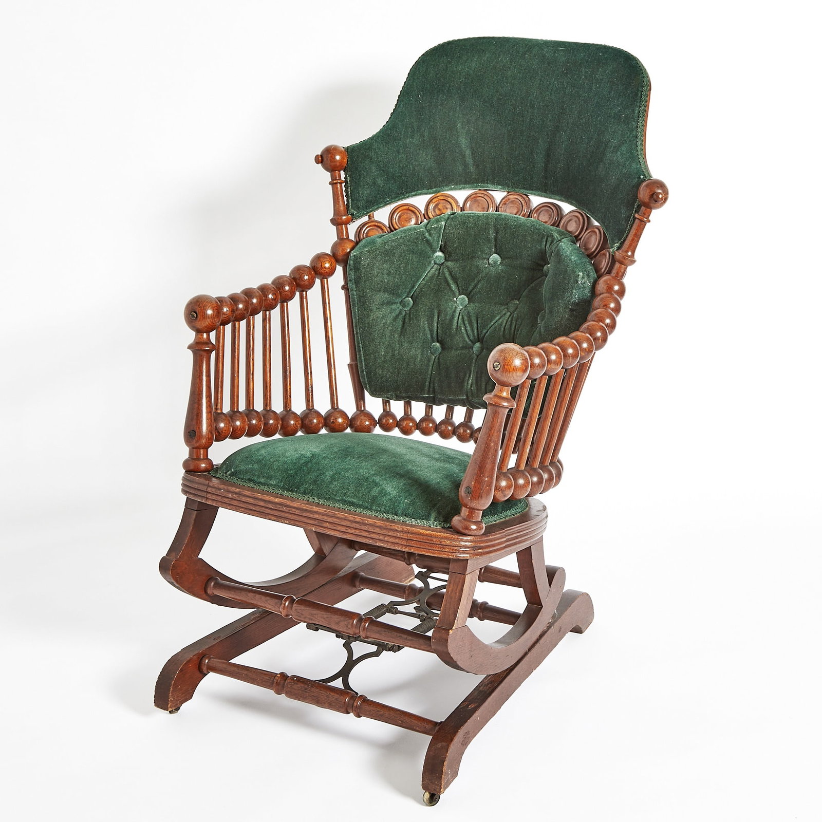 Hunzinger Oak "Lollipop" Platform Rocking Chair: Late 19th century With upholstered and part-tufted backrest, embossed maker's label on underside of seat. Height 41 inches.