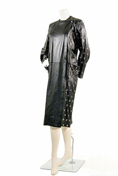 Alaia Couture Grommet Studded Black Leather Coat: Alaia Couture Grommet Studded Black Leather Coat French, 1981 Double breasted with high square neckline, front and back panel narrowing to hem, under piece of long sleeves cut in one with side panel,