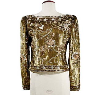 Carolyn Roehm Embroidered Evening Blouse: Carolyn Roehm Embroidered Evening Blouse American, 1980s The waist length blouse with batteau neck and long tapered sleeves, zipper in back, the ground embroidered in matte gold sequins with floral a