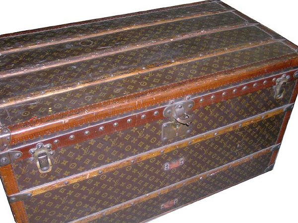 Louis Vuitton Trunk: Louis Vuitton Trunk Monogram canvas, LV stamped wood trim, wooden bands, brass fittings, locks and studs, wheels on base, linen interior with quilted cotton lid, two webbed overlaying trays with cott