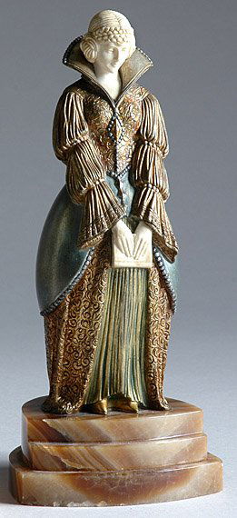 Cold Painted Bronze and Ivory Figure: Cold Painted Bronze and Ivory Figure After a model by Demetre Chiparus, circa 1925 Modeled as a female figure in Renaissance style dress, with bowed head and clasping a book, on a stepped brown and w