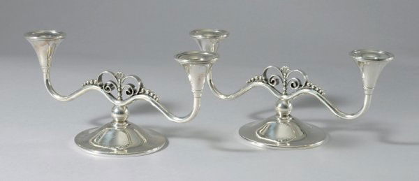 Pair of International Sterling Silver Two-Light C: Pair of International Sterling Silver Two-Light Candelabra Each spherical stem issuing two scrolling branches with beaded decoration ending in candle holders, on a domed disk foot. Height 4 3/4 inche