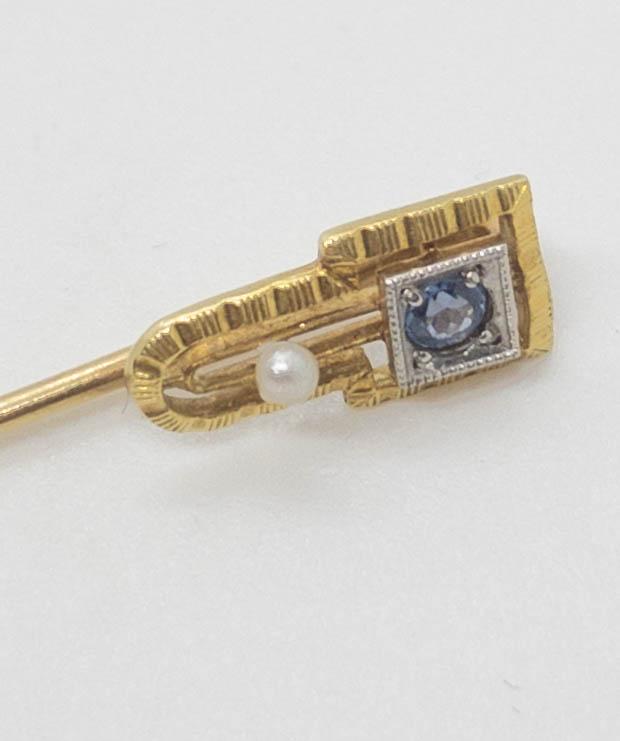 Art Deco 14k Yellow Gold Stick Pin Blue Stone & Seed: Art Deco 14k yellow gold stick pin featuring an engraved setting with a prong set blue stone in a white gold setting and accented with a seed pearl. 2.75" long. Weight: 1.5 grams.