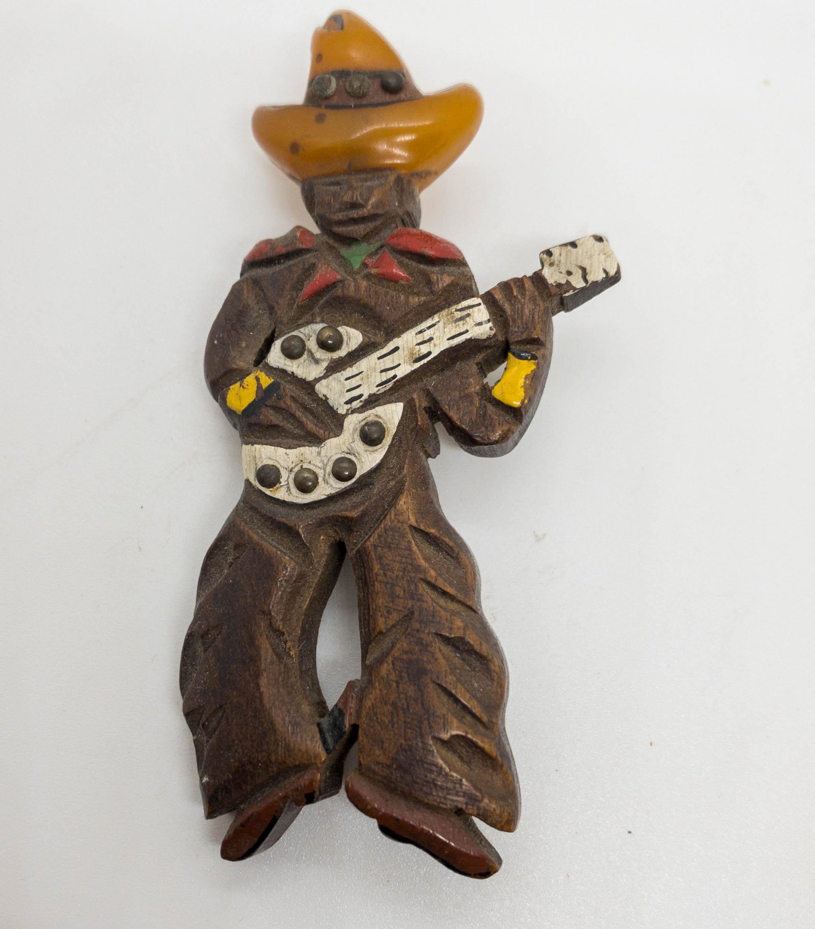 Vintage Carved Wood & Bakelite Cowboy Brooch Pin: Hand carved vintage cowboy brooch hand painted with a bakelite hat. 3.75" long x 1.75" wide.