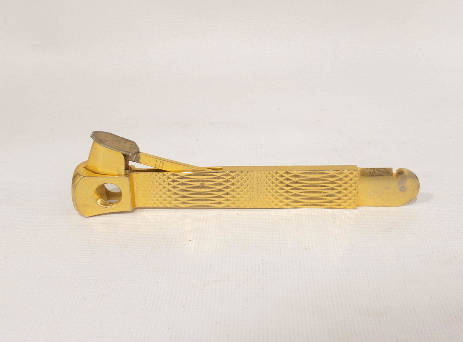 Vintage West Germany Dunhill Cigar Cutter: Vintage Dunhill cigar cutter in textured gold tone. Marked: Dunhill, Made in Western Germany. 5.75" long x .75" wide.