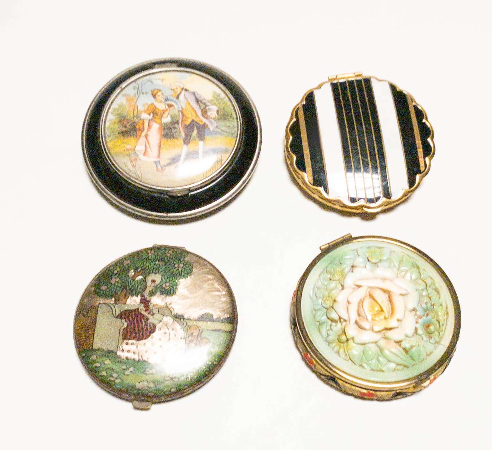 Collection of 4 Vintage Powder Compacts, Gwenda,: A collection of 4 vintage compacts including: a sculptural composite topped compact with a pink rose, 2.25" diameter, a painted courting scene compact, 2.75" diameter, a black and white enamel striped