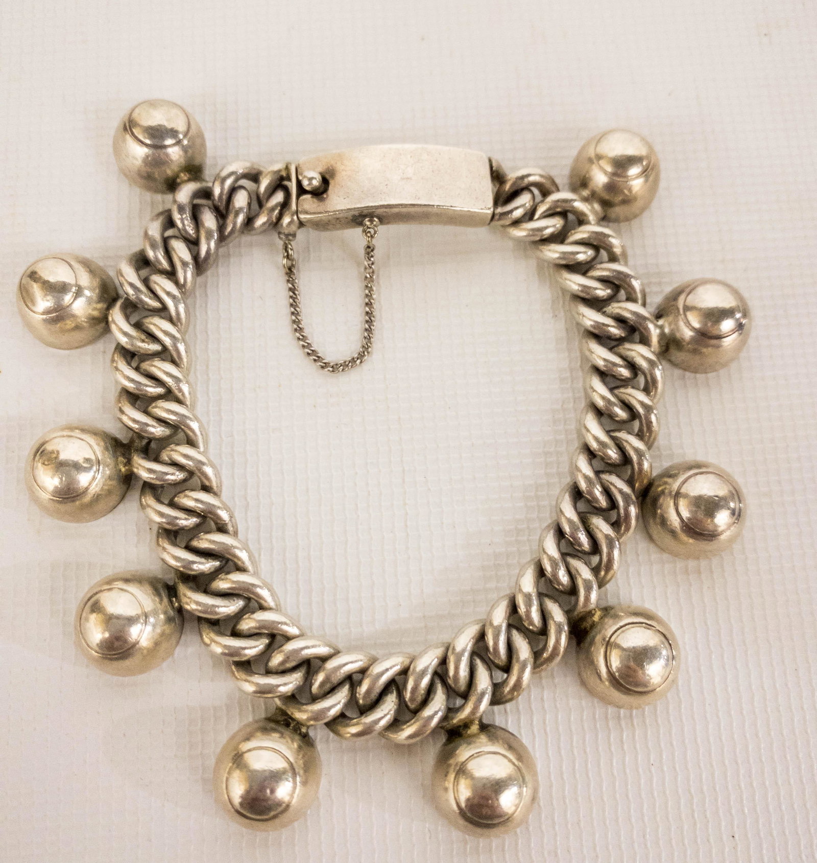 Los Castillos Taxco, Mexico Sterling Silver Ball Charm: Los Castillos, Taxco, Mexico sterling silver chain link bracelet with dangling half ball charms. 7" long, chain is .25" wide Stamped Sterling, Taxco, Mexico, Los Castillos, 711. Weight: 60.4 Grams.